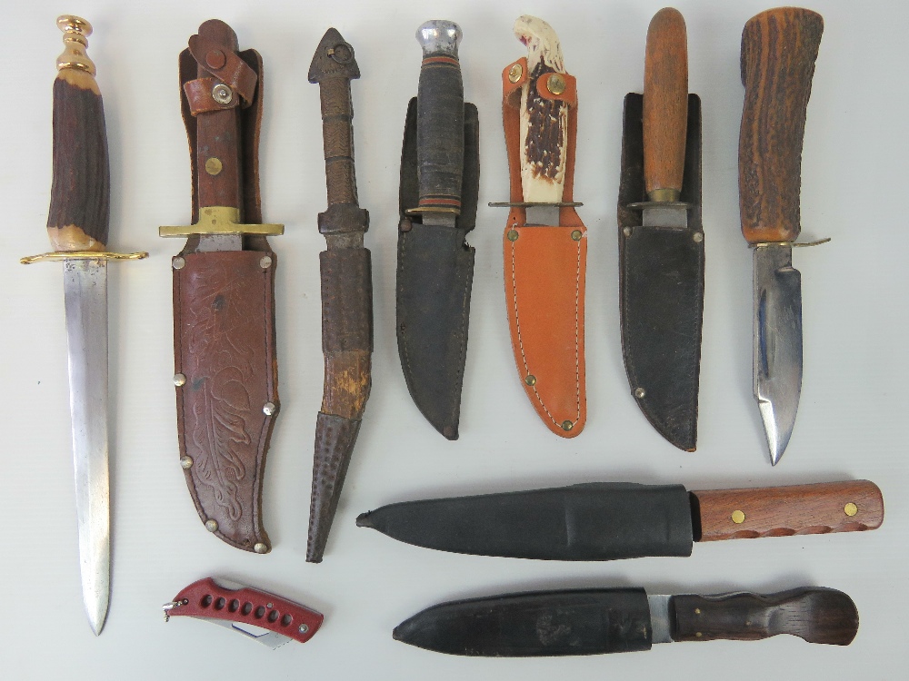 Seven daggers with scabbards, together with a pen knife and two other knives without scabbards.