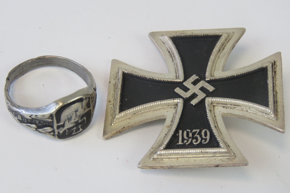 A WWII German Iron Cross 1st Class together with an Iron Cross ring (a/f cut band). Two items.