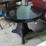 A smart gloss black circular centre table raised over solid triform base, 97cm dia.