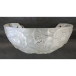 An Art Deco frosted glass wall lamp shade relief moulded with stylized flower heads, 24cm wide,