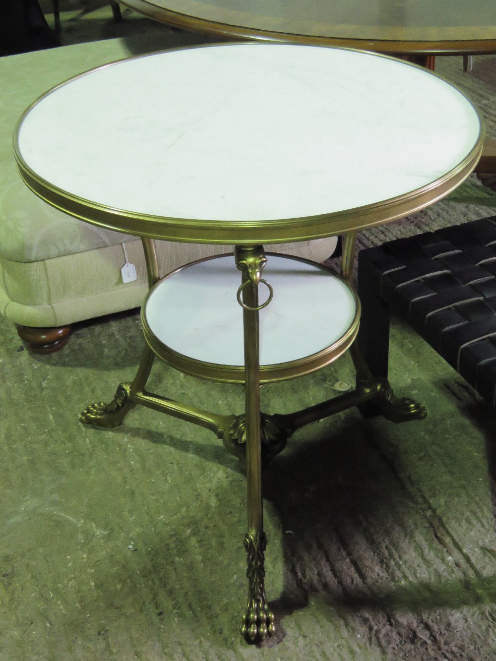 A white marble circular table in the Classical style having gilded metalwork throughout,