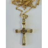 A 9ct gold cross having inset white stones, stamped 375, on 9ct gold fancy link chain, stamped 9c.