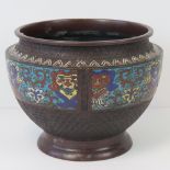 A large bowl having three decorative cloisonné panels upon all within the cellular geometric