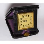 A Deco Period Harrods leather cased folding travel clock. 1.5 inch square dial.