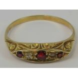 A ruby and diamond ring having three graduated rubies separated by two diamonds all set in yellow