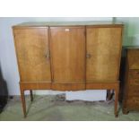 A quarter veneered light mahogany break front sideboard on stand comprising central draw flanked by