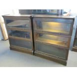 A pair of three sectional Globe Wernicke style glazed 'up and over' library bookcases in stained