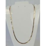 A 9ct gold tri-colour necklace, three strands of snake link chain in rose,