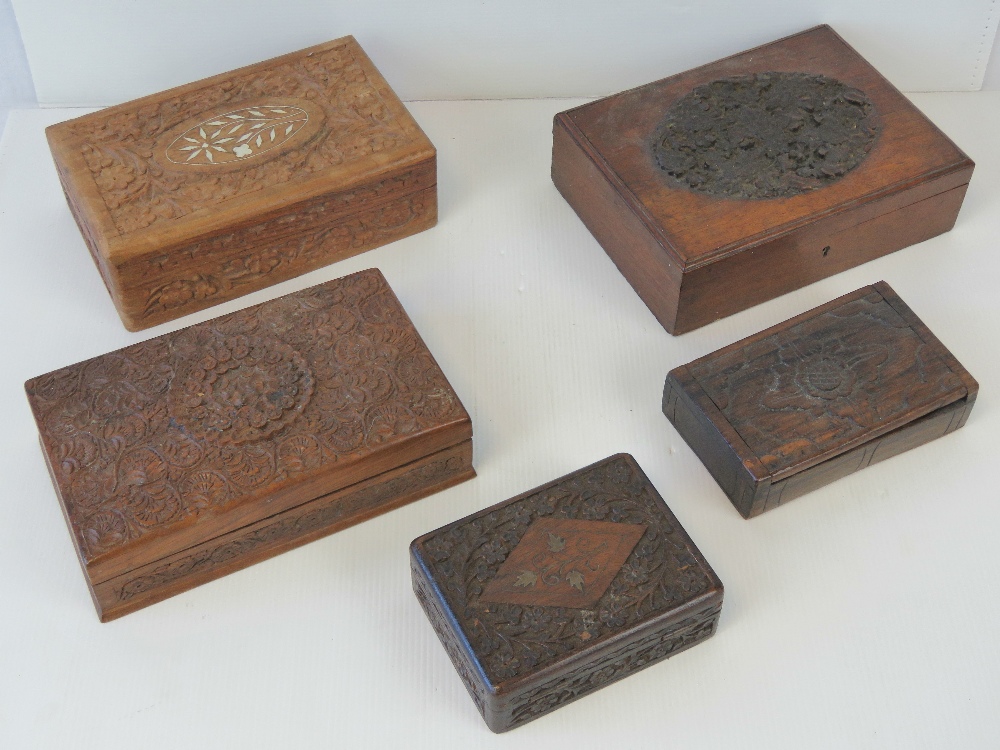 A mahogany rectangular box with carved and raised oval medallion to the lid and other carved