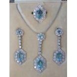 A stunning Art Deco diamond and aquamarine suite comprising ring, earrings and necklace.