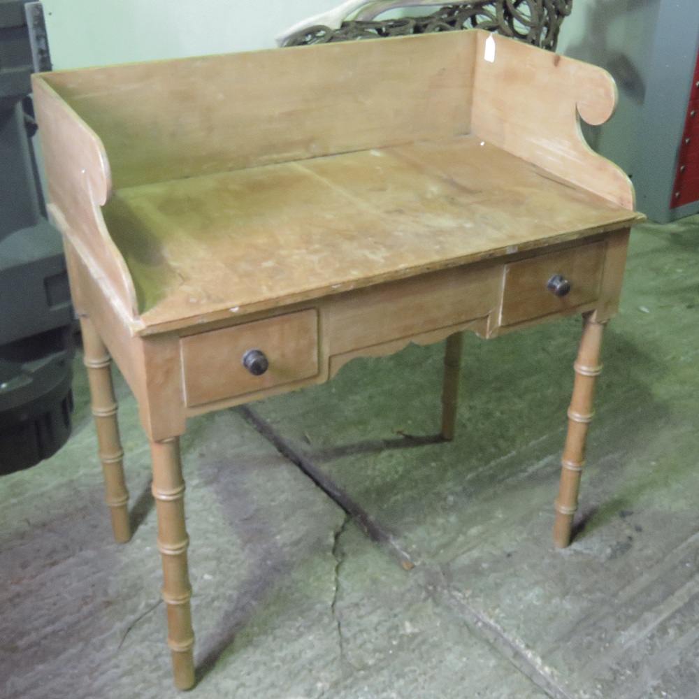 A Victorian pine washstand having twin box drawers and all raised over bamboo style legs, 92cm wide.