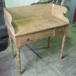 A Victorian pine washstand having twin box drawers and all raised over bamboo style legs, 92cm wide.