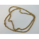 An 18ct gold rope twist necklace in yellow gold having strands of white and rose gold box link