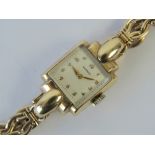 A 9ct gold Movado cocktail watch having 9ct gold strap,