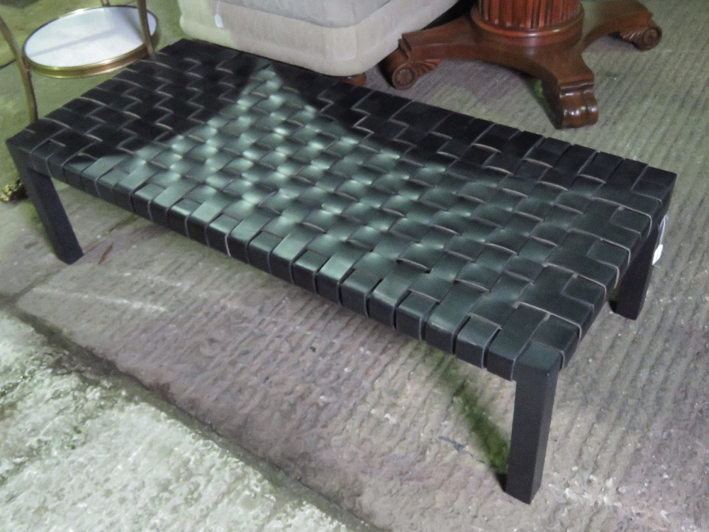 A Ralph Lauren woven black leather stool raised over square shaped legs and bearing label upon,