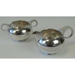 A HM silver sugar bowl and matching HM silver jug, having graduated loop handles, jug 14.