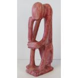 A contemporary abstract pink marble figurine of 'The Thinker', 30.5cm high.