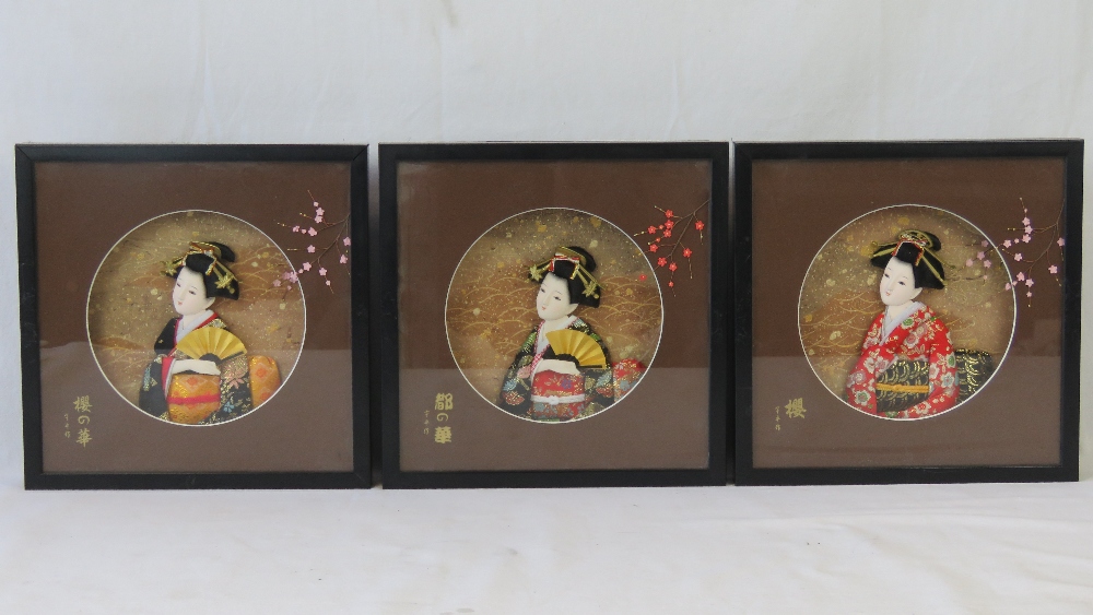 Three framed relief geisha girl busts in decorative settings. Frames 18 x 18cm.