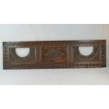 A carved oak three panel overmanle panel, 147cm wide, 40cm high.