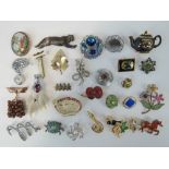 A quantity of assorted 20th century brooches including; a fob watch by Sambra, floral examples,