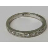 An 18ct white gold and diamond half eternity ring having twelve round cut diamonds, stamped 18ct,