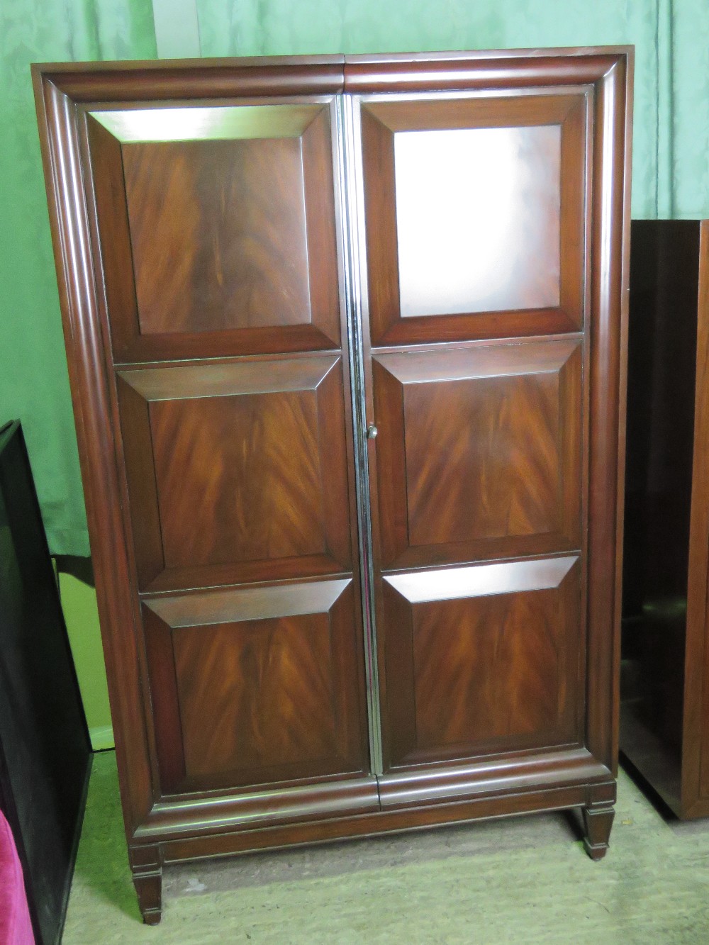 A Ralph Lauren two door drawing room cabinet having field moulded panel doors opening doors opening