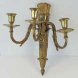 A gilt brass three branch wall applique of classical design with arrows and quiver and putti