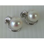 A pair of 18ct white gold and pearl clip on earrings, each having single white pearl approx, 8.
