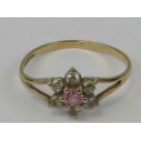 A 9ct gold daisy cluster ring with white stone petals and central pale pink stone, hallmarked 375,