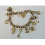 A 9ct rose gold heavy curb link charm bracelet having heart padlock clasp,