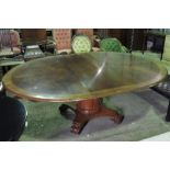 A large and impressive polished walnut centrepiece table raised over a pillar stem upon quatreform