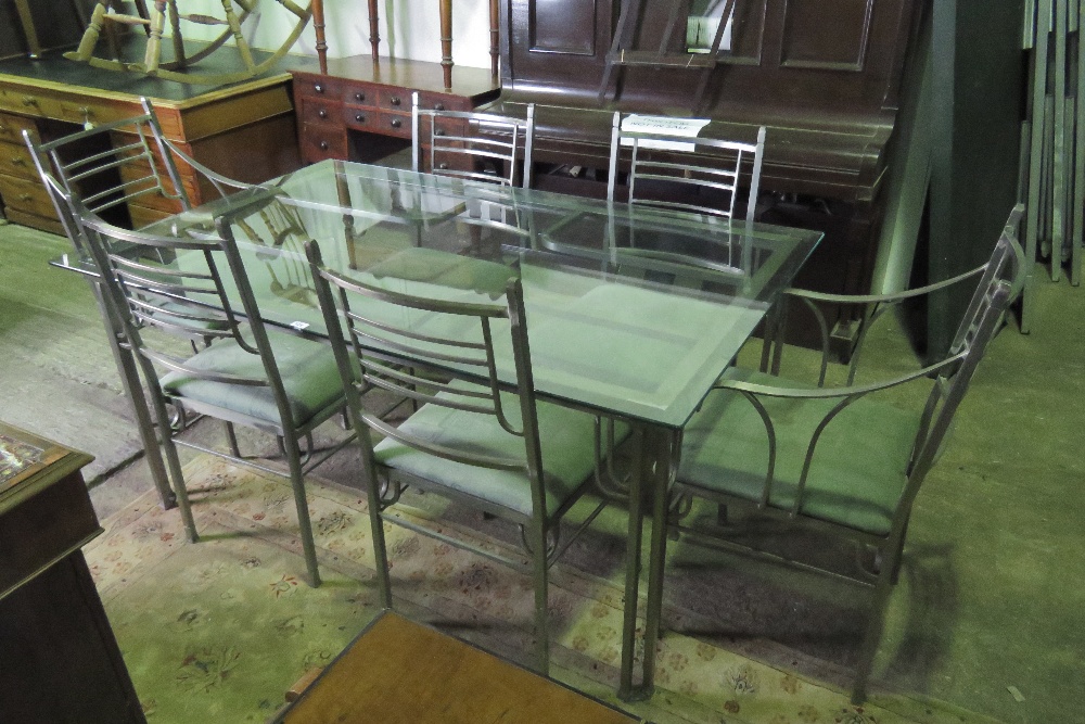 A contemporary metal framed dining table having glass top, 163 x 102cm,