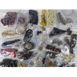 A quantity of assorted vintage costume jewellery including carved bone necklaces, bead necklaces,