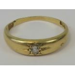 A n 18ct gold and diamond gypsy ring, central round cut diamond in star setting,