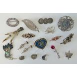 A quantity of silver and white metal brooches including; sterling filigree leaf,