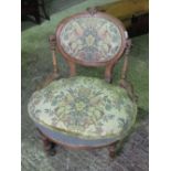 A Victorian mahogany gentlemans drawing room chair having profusely shaped and scrolled frame,