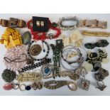 A quantity of assorted vintage costume jewellery including; necklaces, bracelets, bangles, brooches,