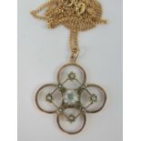 A delightful Edwardian openwork pendant set with seed pearls and having central round cut white