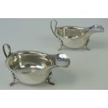 A pair of HM silver sauce boats having pie crust edge and raised over three outswept feet,