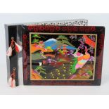 A vintage Japanese black lacquer musical photograph album having hand painted scene upon with