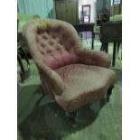 A late Victorian spoon back low fireside ladies chair raised over mahogany legs.