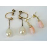 A pair of angel skin coral earrings having yellow metal hangers,