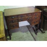 A mahogany knee hole work desk having central drawer flanked by three graduated drawers to each