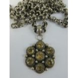 A silver daisy cluster pendant set with citrines.