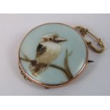 A delightful 9ct gold brooch having central circular ceramic plaque with hand painted hand painted