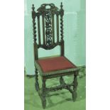 A Victorian Carolian revival single chair having pierced and carved decoration and raised over