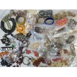 A quantity of assorted vintage costume jewellery including necklaces, bangles and bracelets.