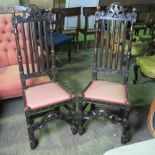 A pair of upright stained oak Carolian revival hall chairs with upholstered seats.
