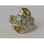 An impressive 18ct gold diamond and aquamarine cocktail ring having three central oval cut
