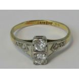 An 18ct gold Art Deco diamond ring having twin round cut brilliant diamonds set in rectangular